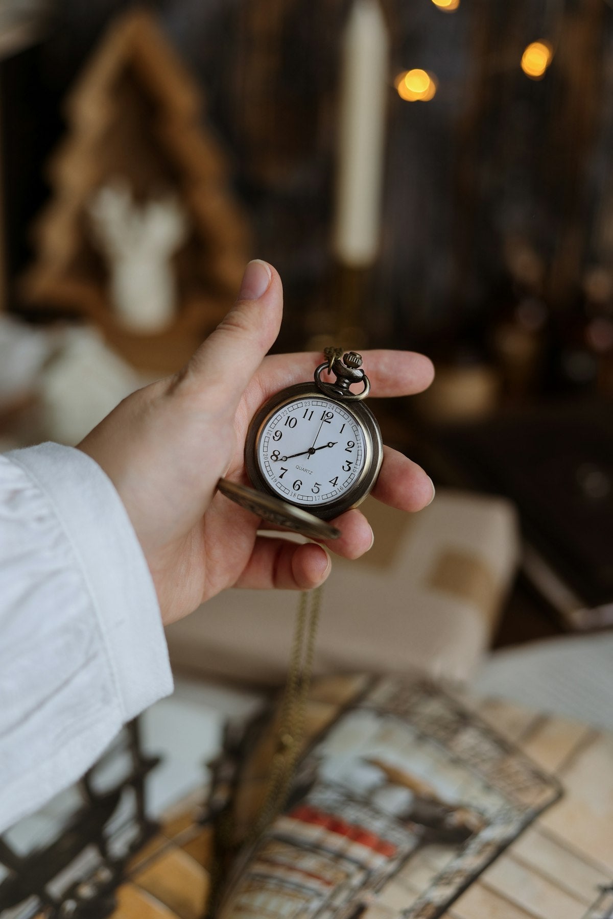 Hand holding an antique pocket watch